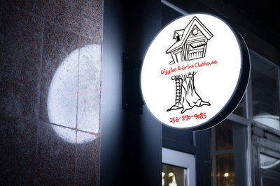Business signage for Giggles and Grins Clubhouse